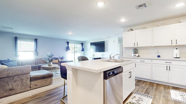 kitchen featuring open floor plan, stainless steel dishwasher, a sink, and visible vents