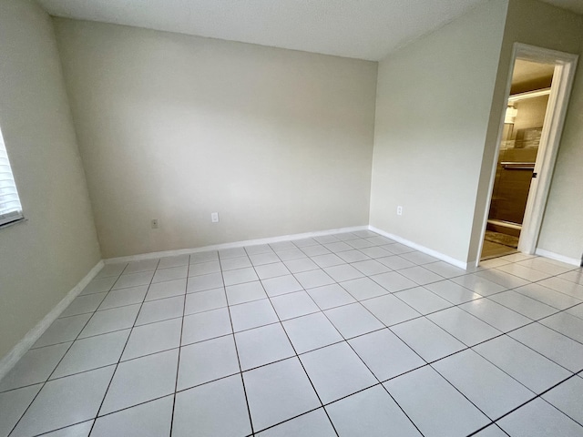 unfurnished room featuring baseboards