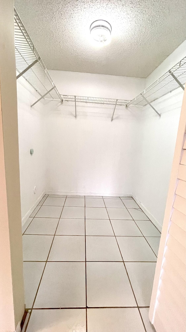 spacious closet featuring tile patterned flooring