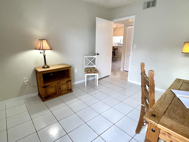 office featuring light tile patterned floors, baseboards, and visible vents