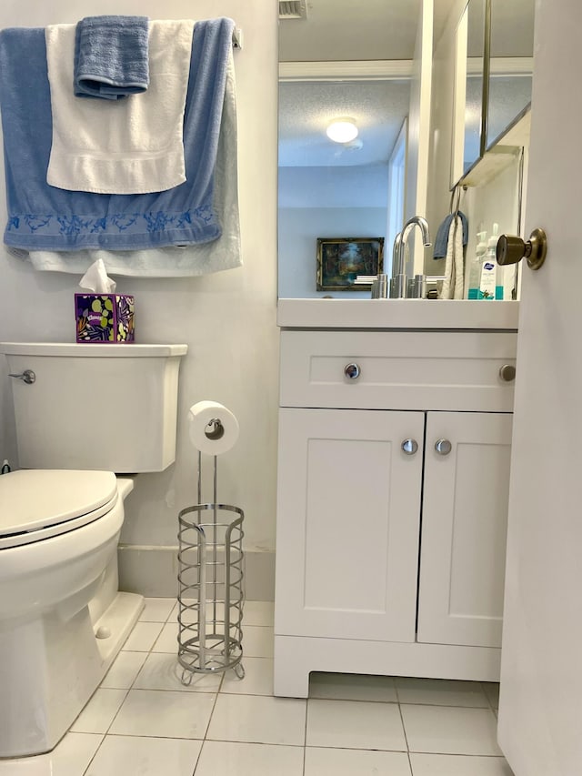 half bath featuring visible vents, toilet, vanity, a textured ceiling, and tile patterned floors