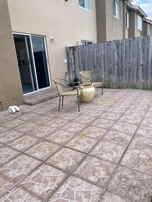 view of patio featuring fence