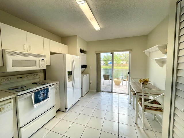 kitchen featuring light tile patterned floors, a textured ceiling, white appliances, white cabinetry, and light countertops