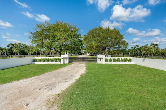 exterior space featuring a fenced front yard and driveway