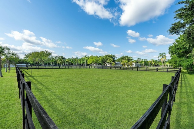 view of yard featuring a rural view and fence