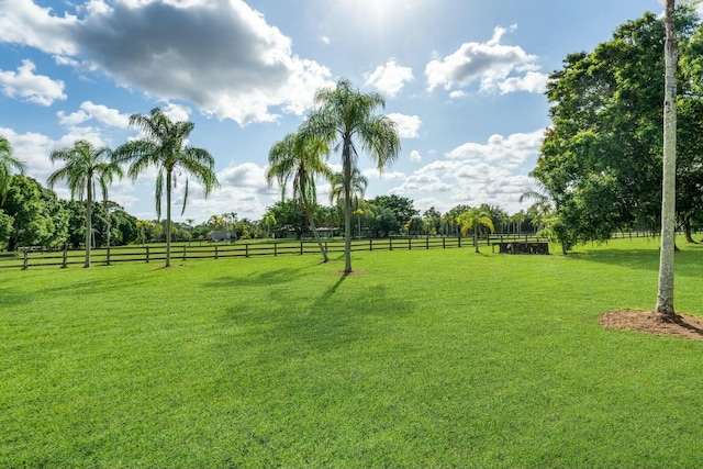 view of yard with a rural view and fence