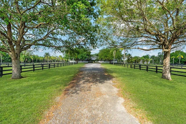 view of road with driveway and a rural view