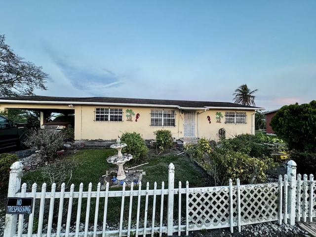 single story home with a fenced front yard and stucco siding