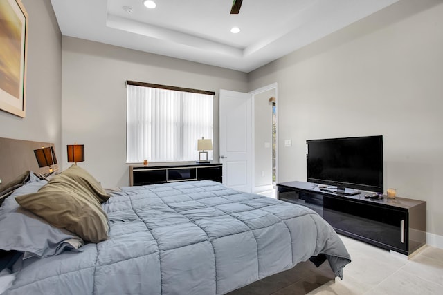 bedroom featuring recessed lighting, a raised ceiling, ceiling fan, baseboards, and tile patterned floors