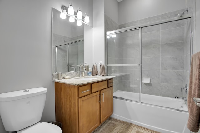 full bathroom with toilet, combined bath / shower with glass door, and vanity