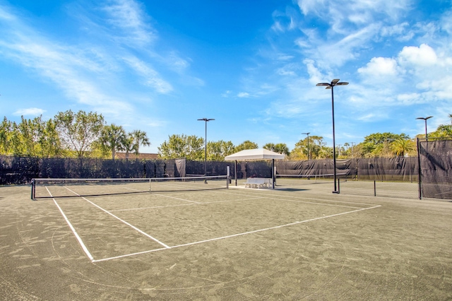 view of tennis court with fence