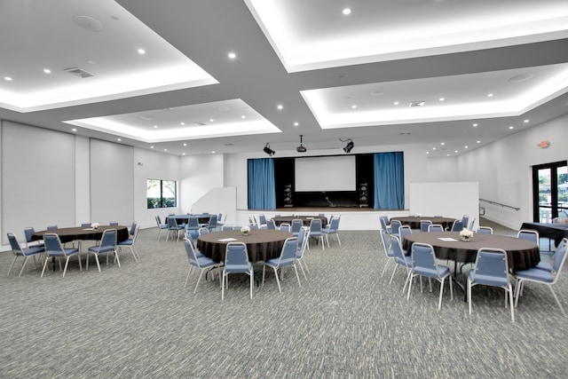 dining room with a tray ceiling, carpet flooring, visible vents, and recessed lighting