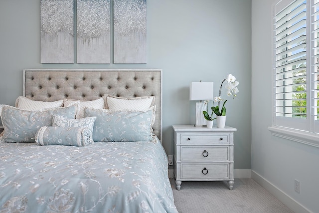 bedroom featuring carpet and baseboards