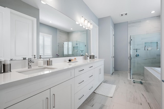 full bath featuring a shower stall, double vanity, visible vents, and a sink