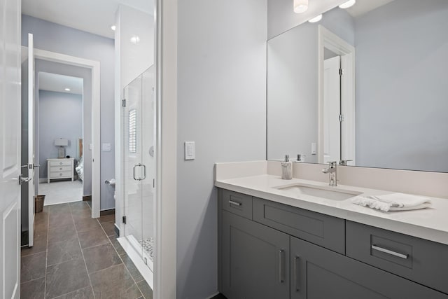 bathroom featuring baseboards, a stall shower, ensuite bathroom, tile patterned floors, and vanity