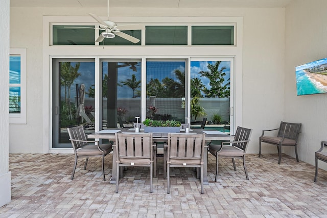 view of patio with outdoor dining area and ceiling fan