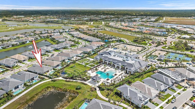 drone / aerial view featuring a residential view and a water view