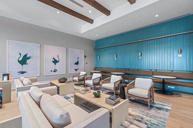 living area with beamed ceiling, recessed lighting, visible vents, and wood finished floors