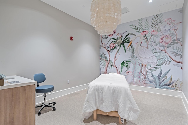 carpeted bedroom featuring an inviting chandelier and baseboards