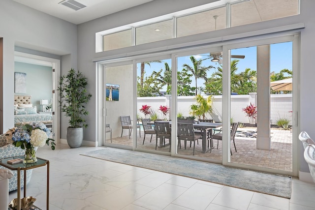 doorway to outside with visible vents, marble finish floor, and ceiling fan