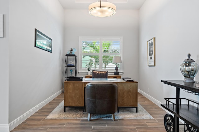 home office featuring baseboards and wood tiled floor