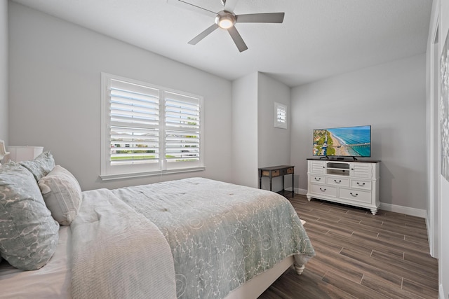 bedroom with baseboards, ceiling fan, and wood tiled floor