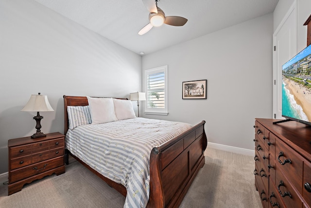 bedroom with baseboards, light carpet, and ceiling fan