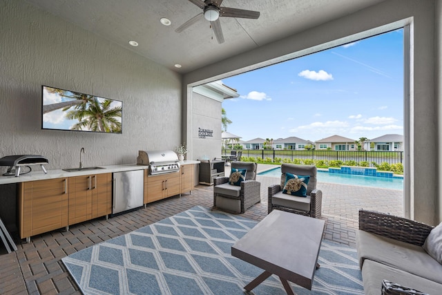 view of patio / terrace with area for grilling, a sink, fence, grilling area, and outdoor lounge area