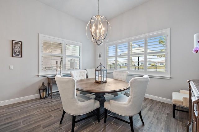 dining room featuring a notable chandelier, baseboards, and wood tiled floor