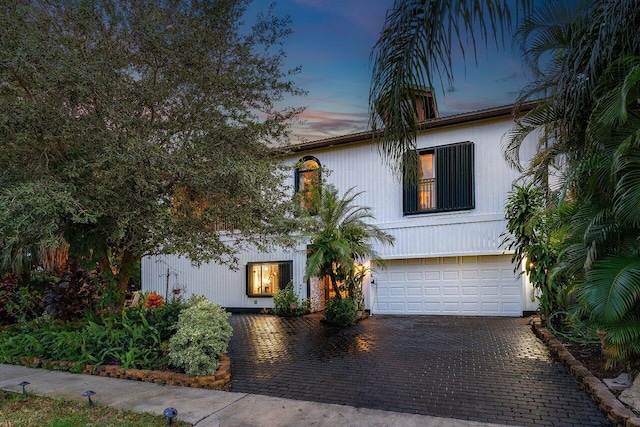 view of front of property with an attached garage and decorative driveway