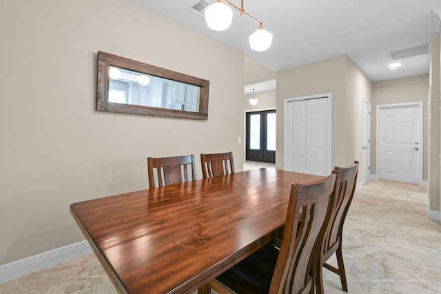 dining area featuring baseboards, visible vents, and french doors