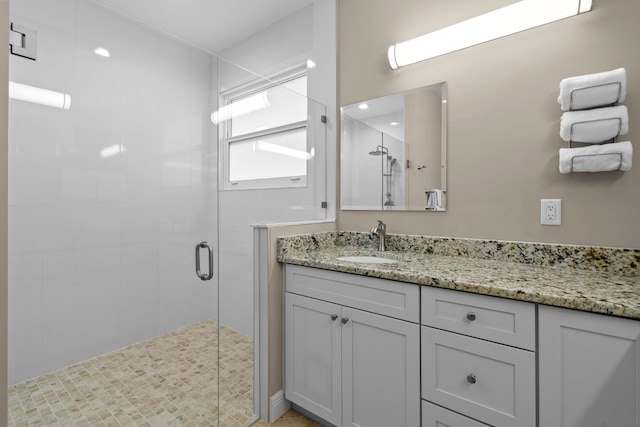 full bath featuring a shower stall and vanity