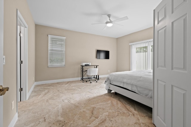 bedroom with ceiling fan and baseboards