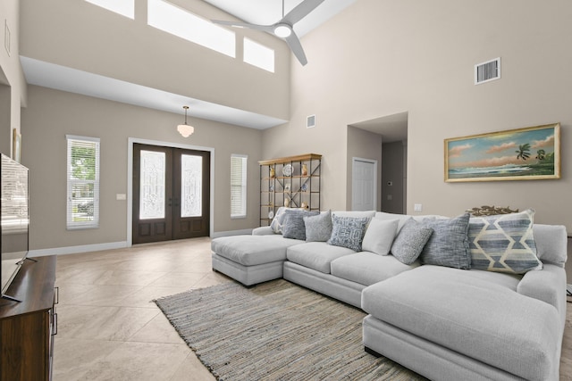 living area featuring light tile patterned floors, baseboards, visible vents, ceiling fan, and french doors