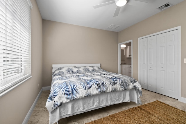 tiled bedroom with baseboards, visible vents, ceiling fan, and a closet