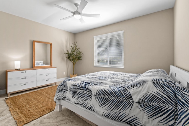 bedroom featuring a ceiling fan and baseboards