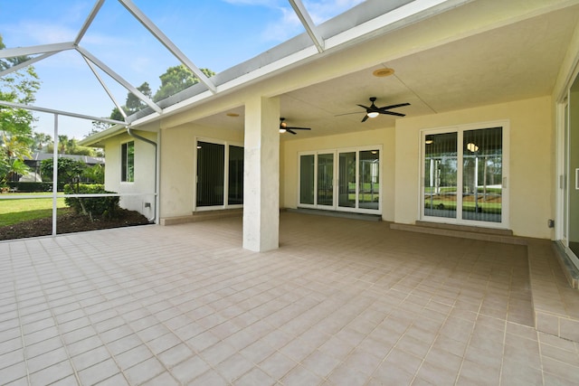 unfurnished sunroom featuring a ceiling fan and a healthy amount of sunlight