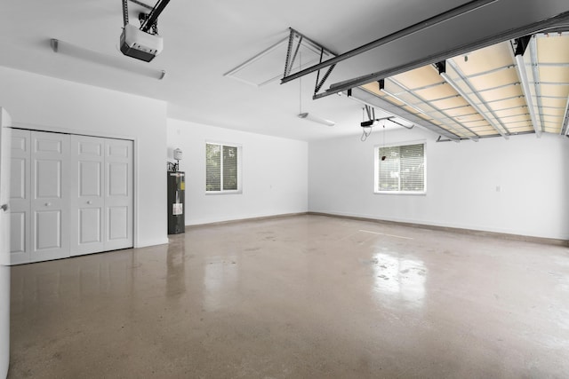 garage featuring water heater, baseboards, and a garage door opener