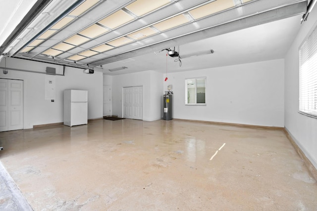 garage featuring a garage door opener, freestanding refrigerator, electric water heater, and baseboards