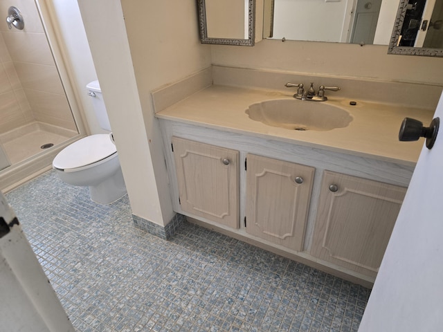 full bathroom featuring toilet, tile patterned floors, a shower stall, and vanity