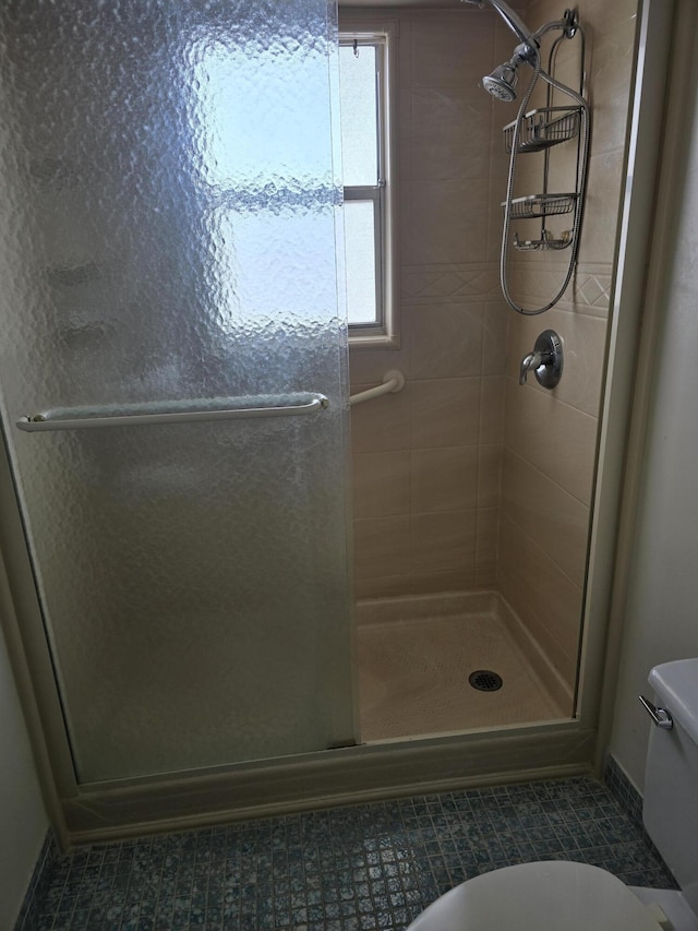 full bath with toilet and a shower stall