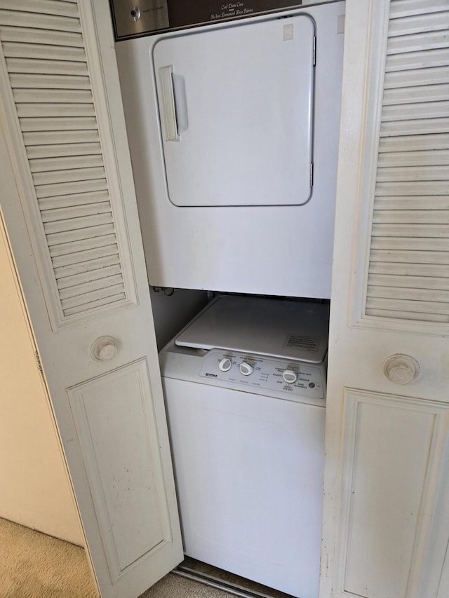 washroom with laundry area and stacked washing maching and dryer