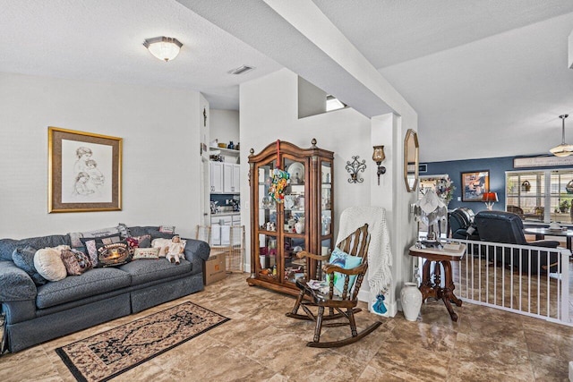 living area featuring a textured ceiling