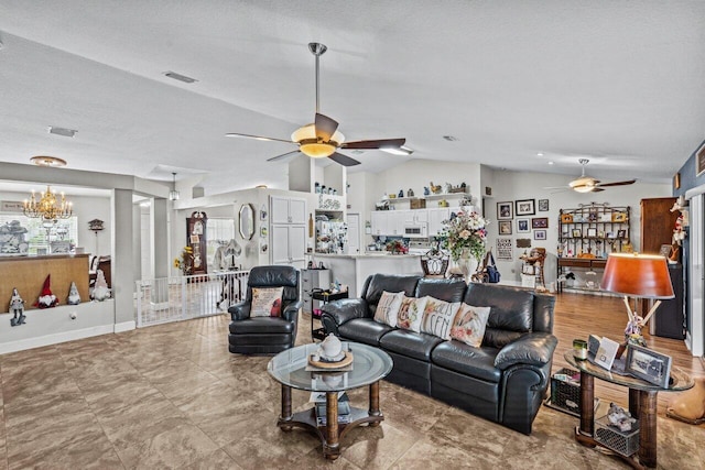 living area with vaulted ceiling, visible vents, plenty of natural light, and ceiling fan with notable chandelier