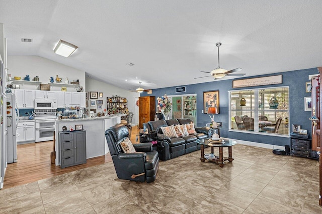 living room with a textured ceiling, visible vents, vaulted ceiling, and a ceiling fan