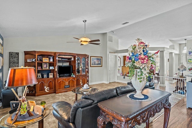 living room with vaulted ceiling, ceiling fan, wood finished floors, and visible vents