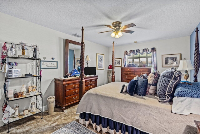 bedroom featuring ceiling fan, visible vents, and a textured ceiling