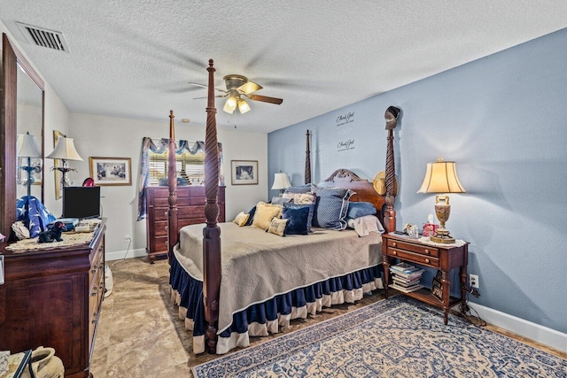 bedroom with ceiling fan, a textured ceiling, visible vents, and baseboards