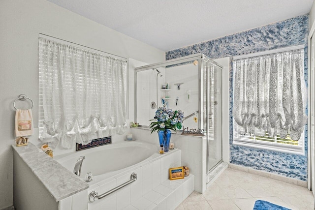 bathroom with a bath, a shower stall, a textured ceiling, and tile patterned flooring