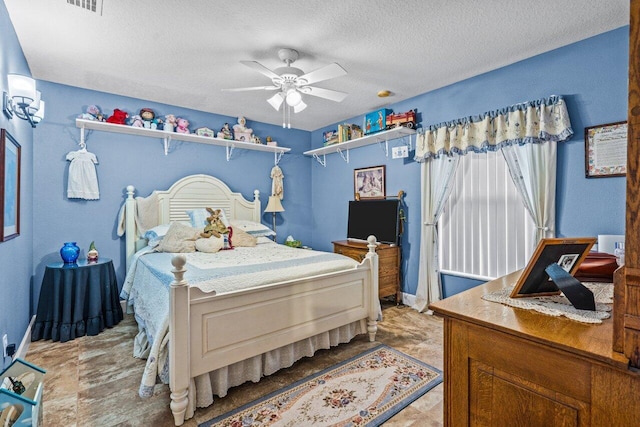 bedroom featuring ceiling fan, visible vents, and a textured ceiling